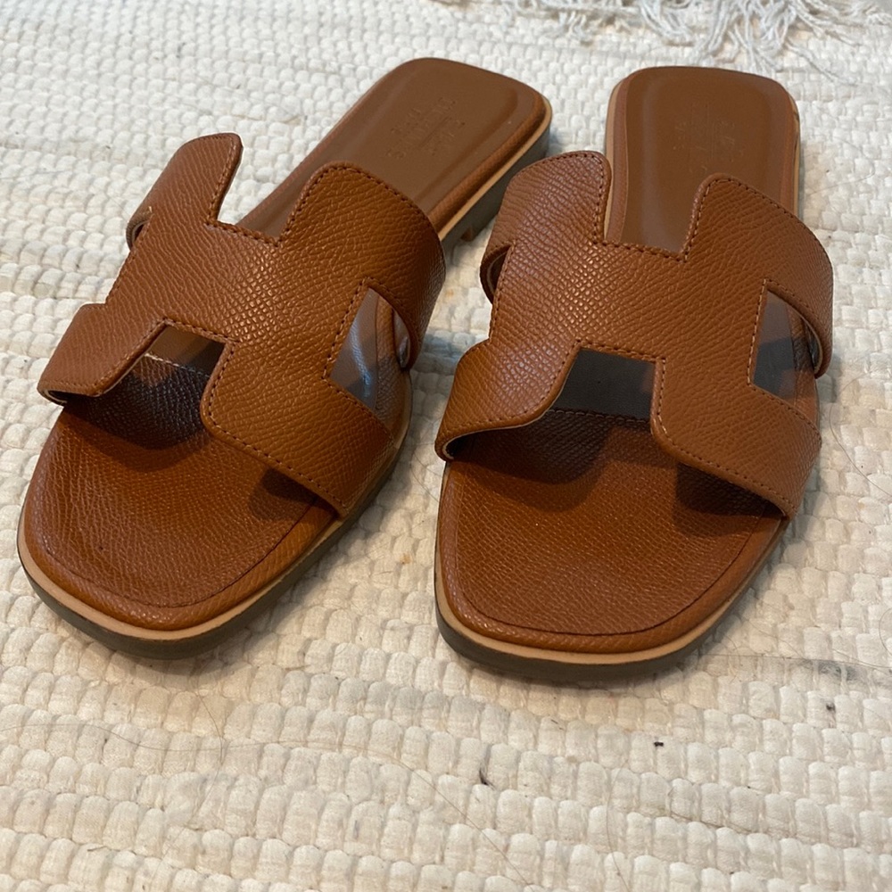 Tan color slide sandal. Reserved.